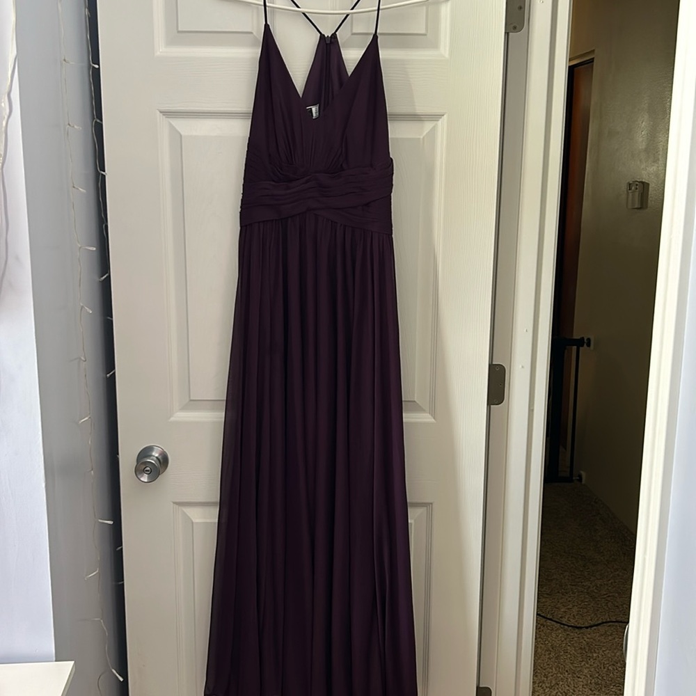 A prom dress 
Size 8 women 
Celebrate brand 
Purple long dress with cross